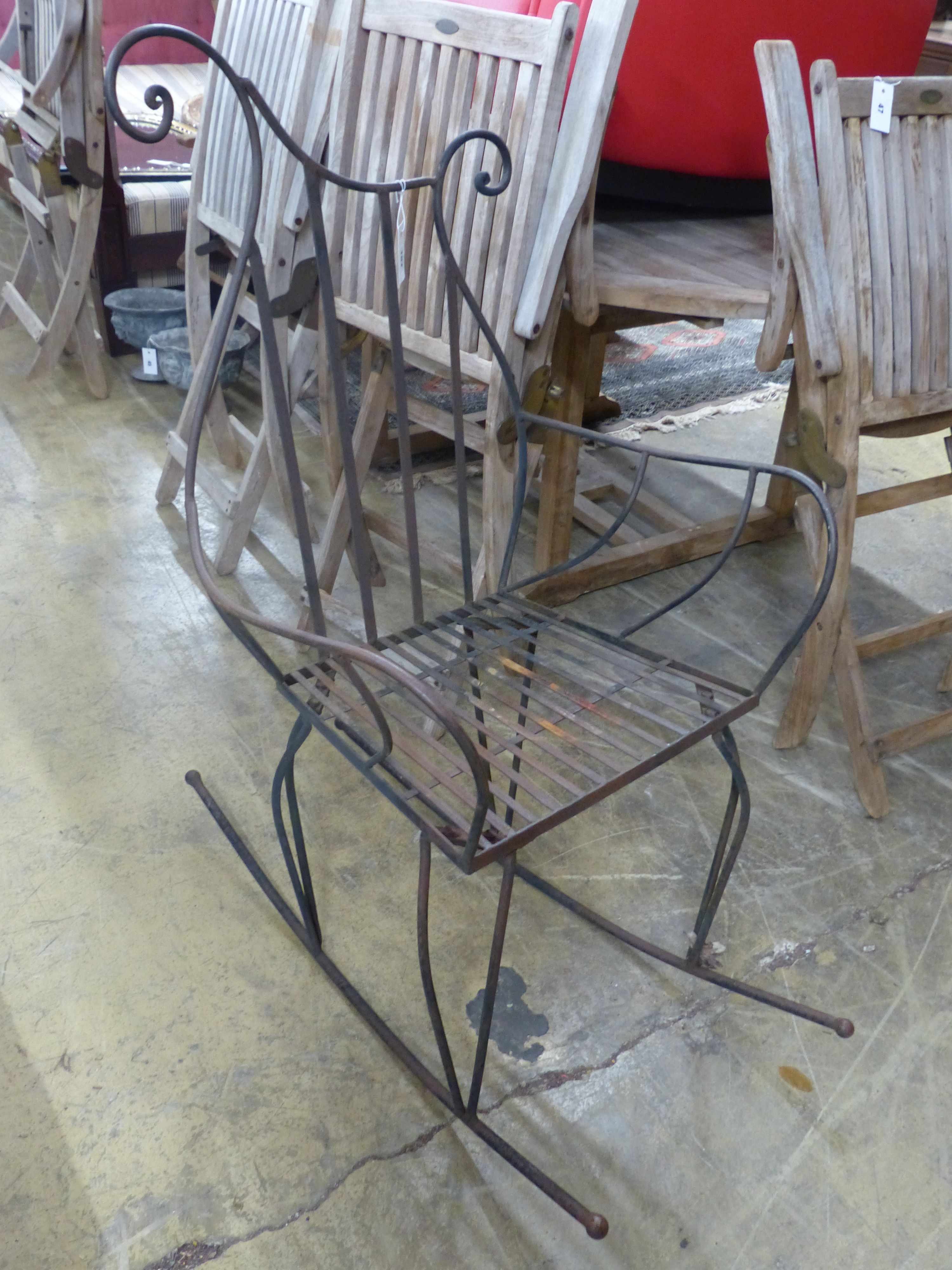 A contemporary wrought iron rocking chair, width 66cm, height 119cm